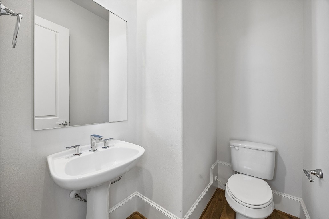 9663 Kings Cross Station Houston, TX 77045 - Photo 12 of 30 a bathroom with a sink a toilet and mirror