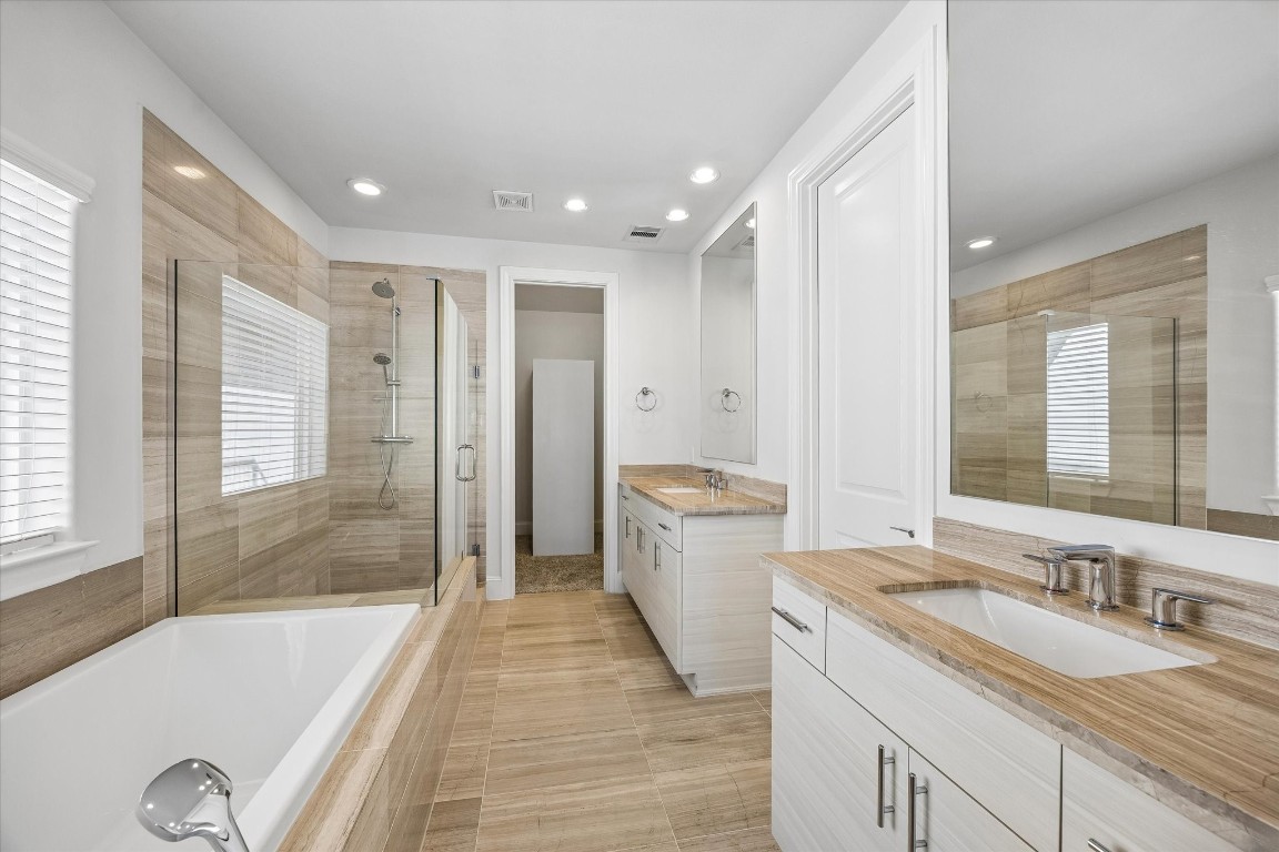 9663 Kings Cross Station Houston, TX 77045 - Photo 15 of 30 a bathroom with a granite countertop sink and a bathtub