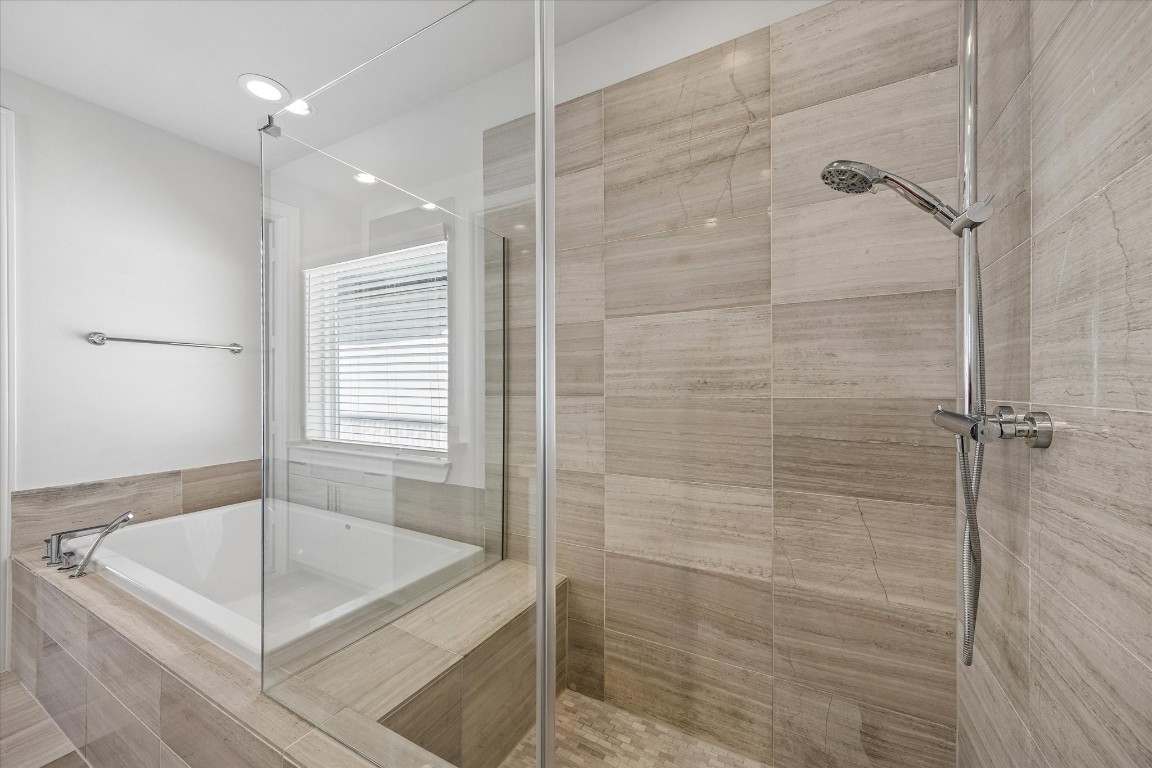 9663 Kings Cross Station Houston, TX 77045 - Photo 16 of 30 a bathroom with a bathtub and shower