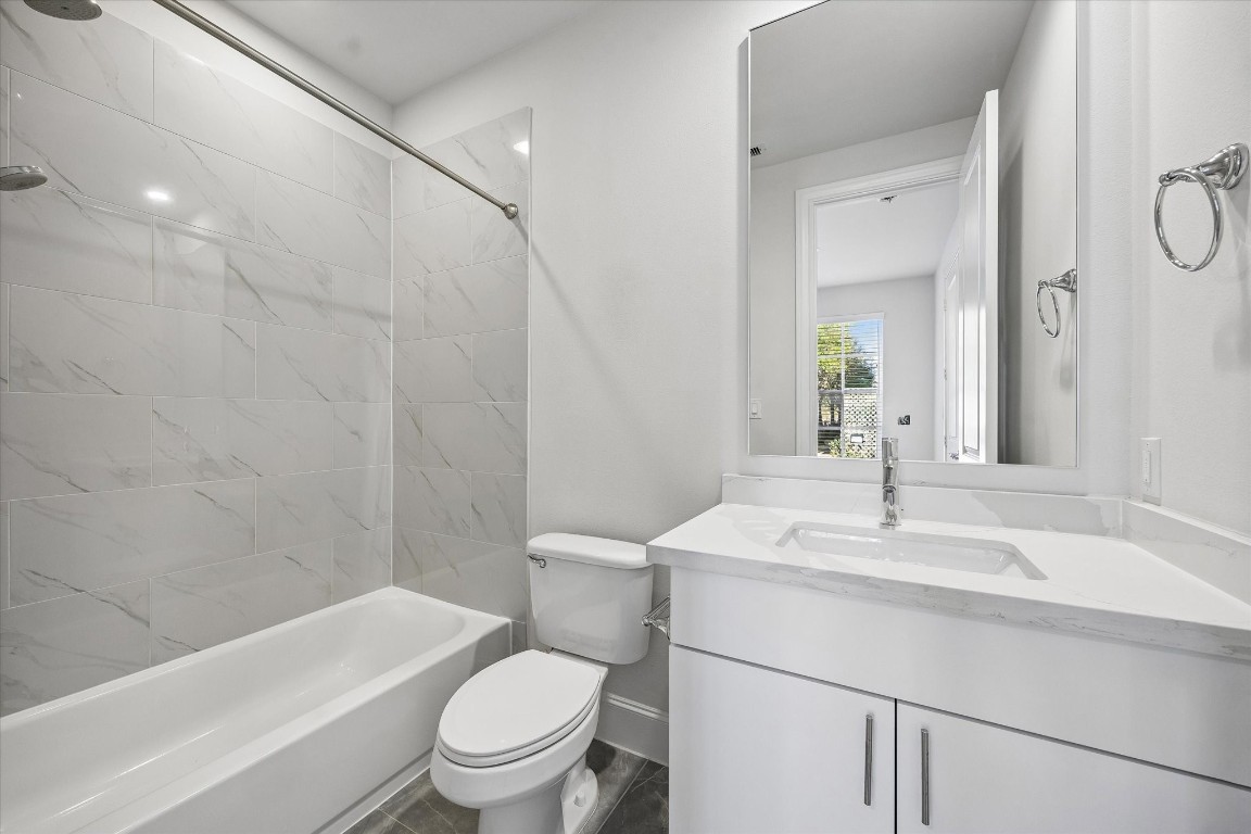 9663 Kings Cross Station Houston, TX 77045 - Photo 22 of 30 a bathroom with a sink a toilet and a bathtub