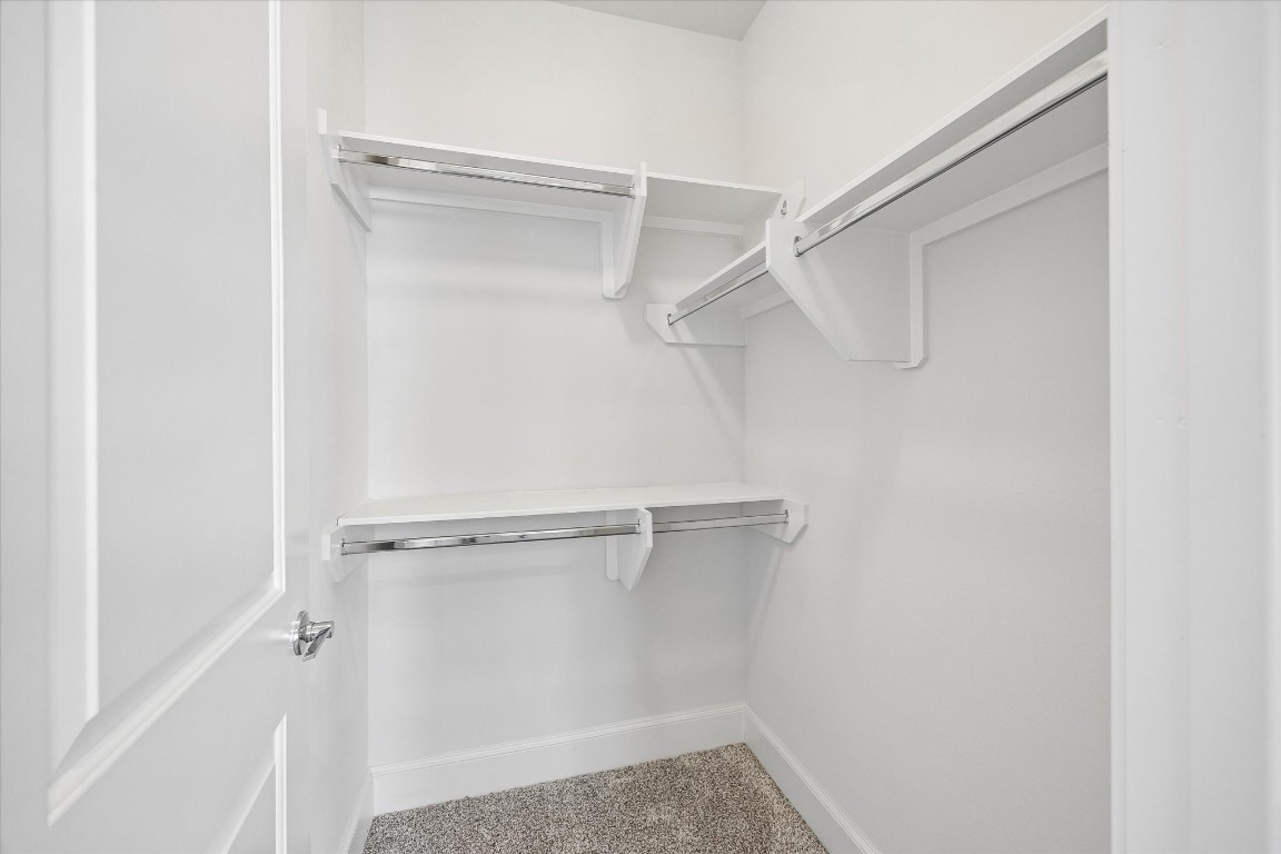 9663 Kings Cross Station Houston, TX 77045 - Photo 23 of 30 a view of walk in closet with empty racks