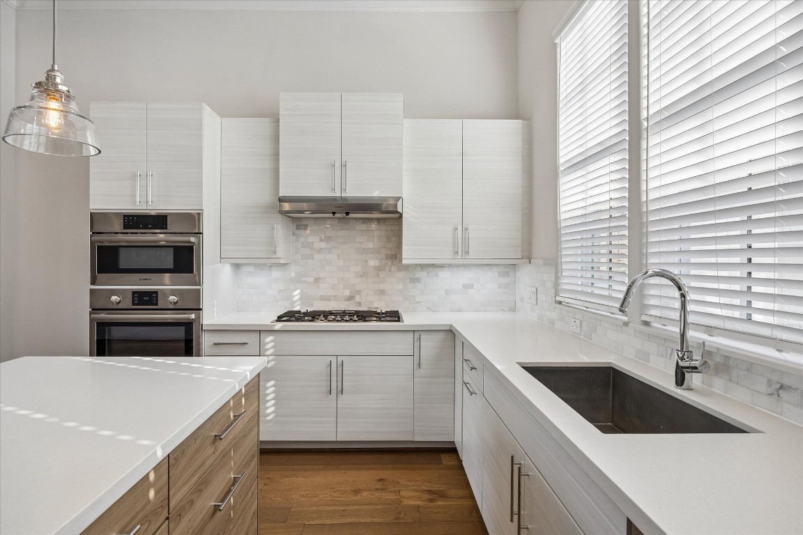 9663 Kings Cross Station Houston, TX 77045 - Photo 3 of 30 a kitchen with a sink white cabinets and white appliances