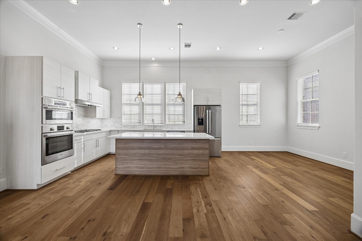 9663 Kings Cross Station Houston, TX 77045 - Photo 5 of 30 a view of kitchen with wooden floor and windows