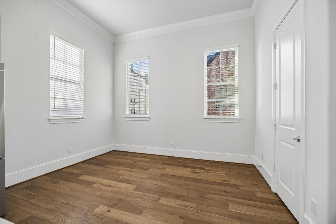9663 Kings Cross Station Houston, TX 77045 - Photo 7 of 30 an empty room with wooden floor and windows