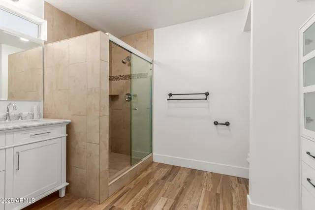 a bathroom with a shower and a sink