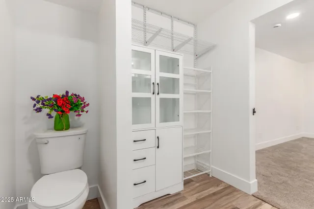 a white toilet sitting next to a vanity