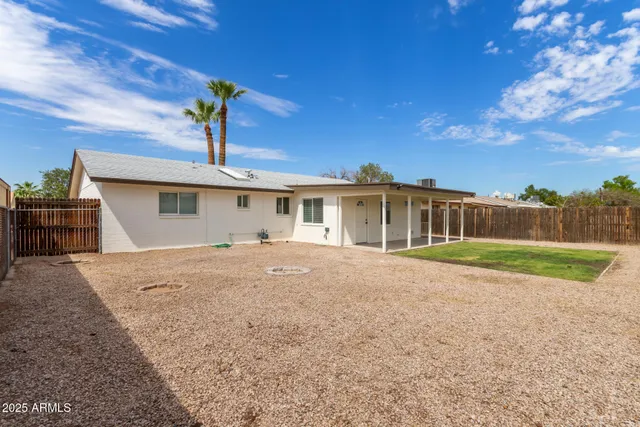 a front view of a house with a garden and yard