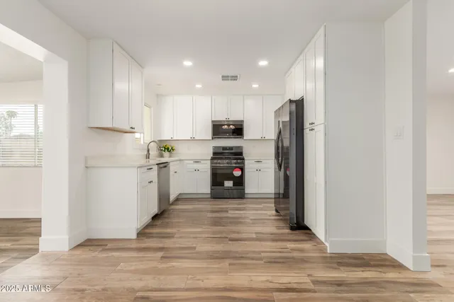 a kitchen with a refrigerator and a sink