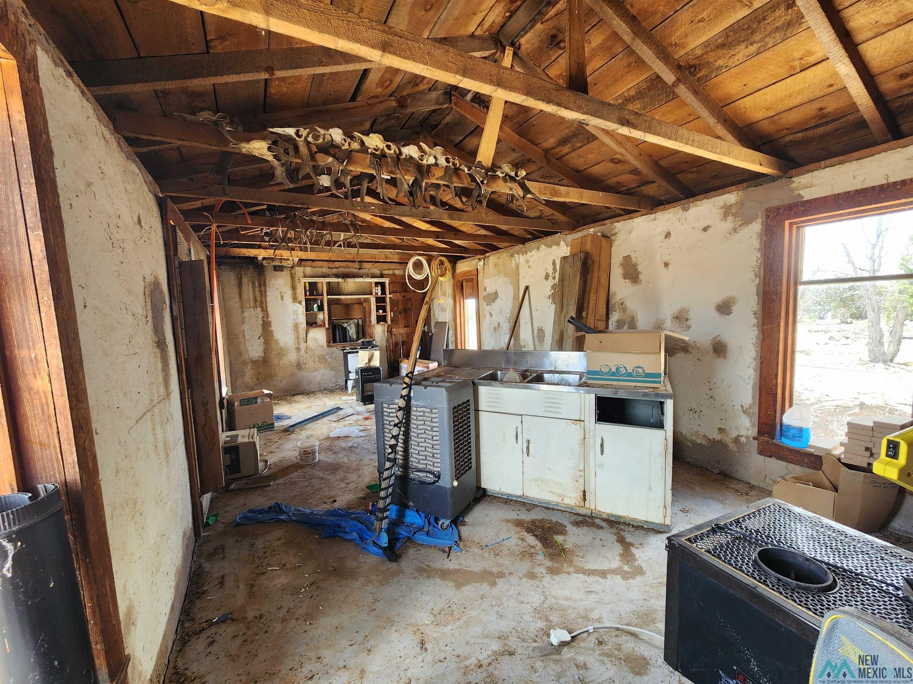 31 Henderson Road Quemado, NM 87829 - Photo 28 of 35 Exposed wood beam ceiling with rough-hewn planking