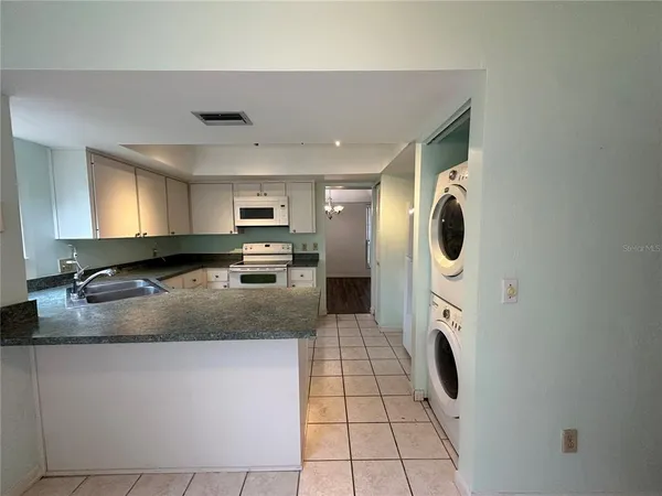 a kitchen with a refrigerator sink and stove
