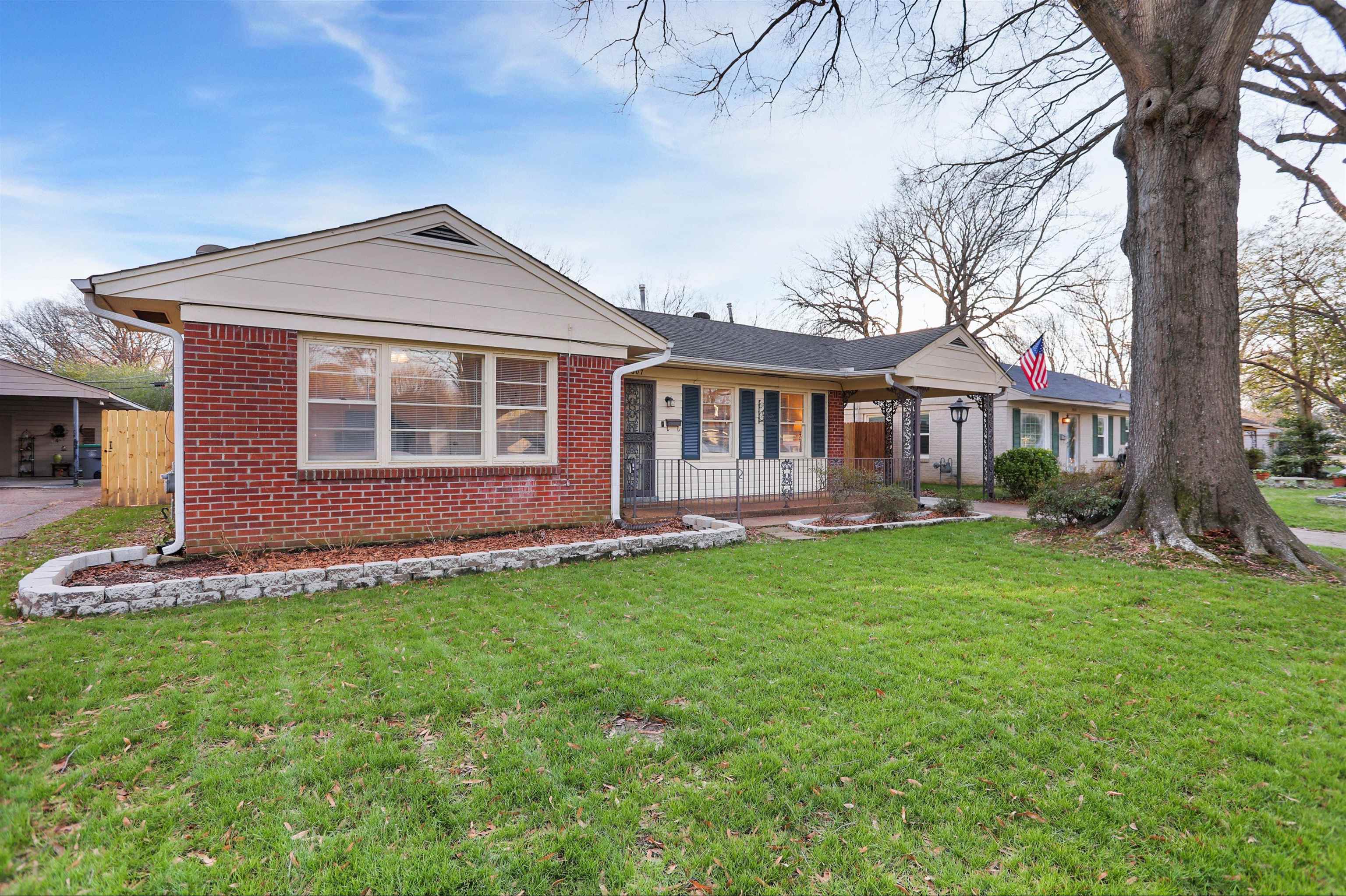 4607 Monaco Road Memphis, TN 38117 - Photo 1 of 25 a front view of a house with a yard