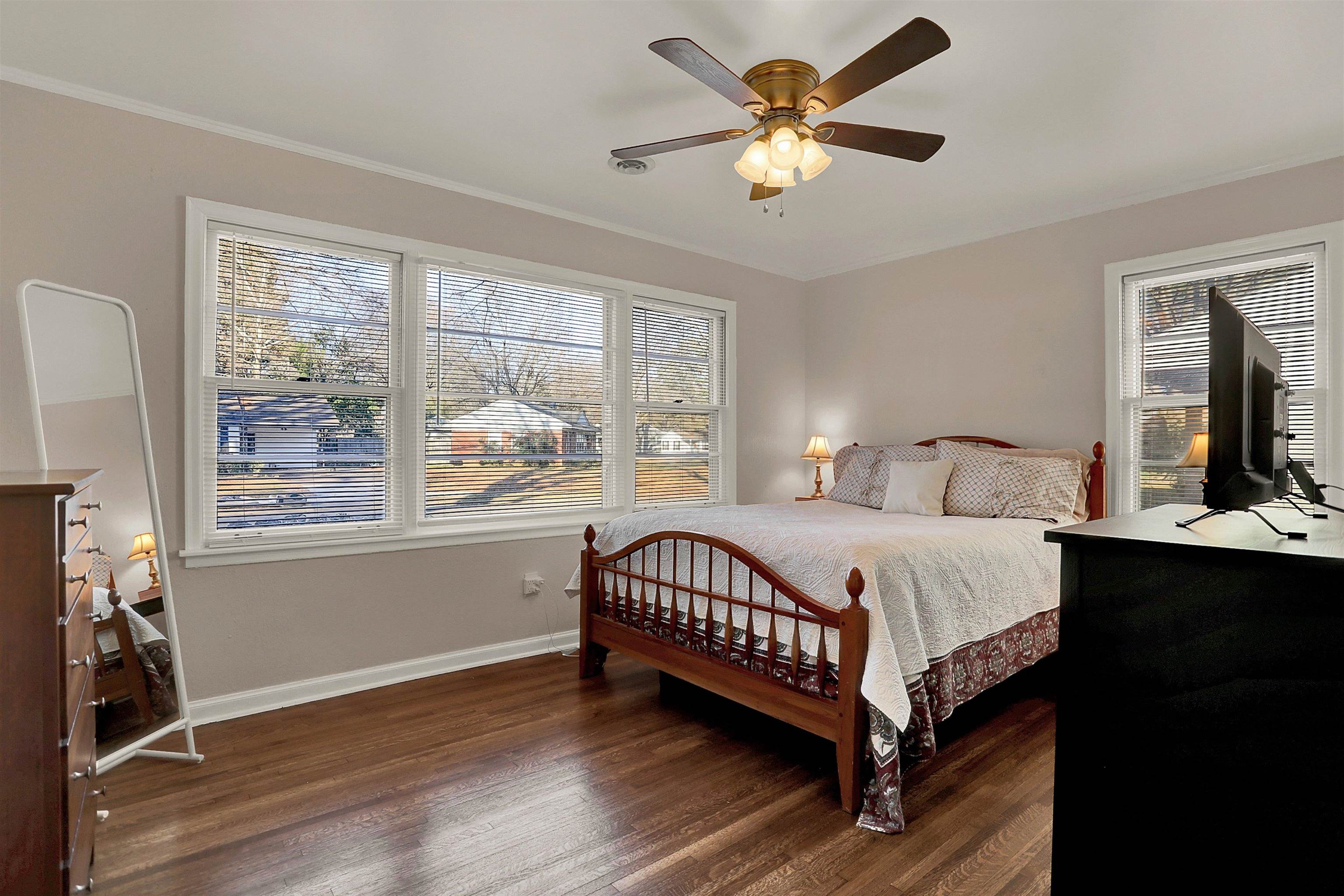 4607 Monaco Road Memphis, TN 38117 - Photo 12 of 25 a bedroom with a large bed chandelier and a window