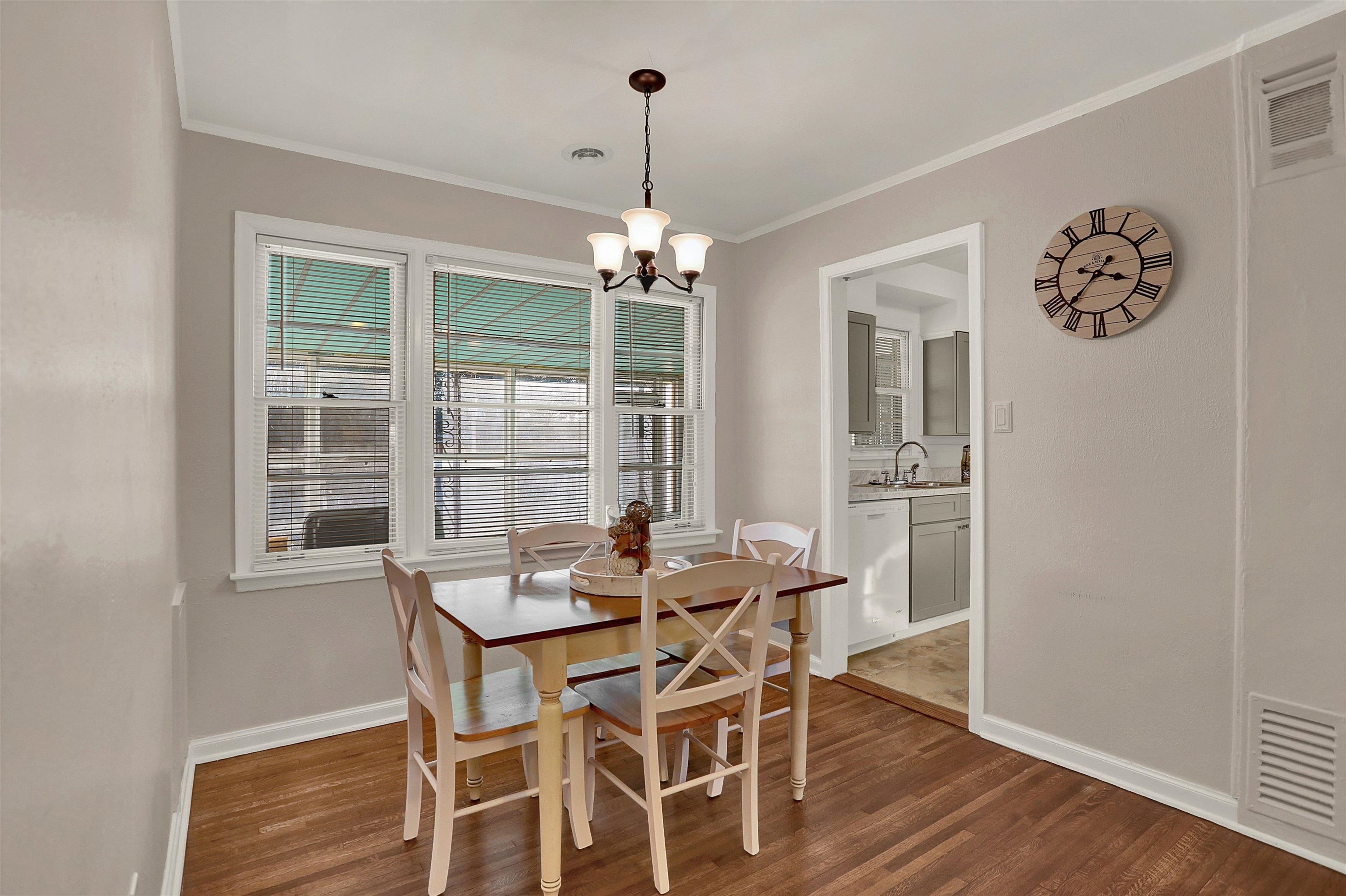 4607 Monaco Road Memphis, TN 38117 - Photo 8 of 25 a dining room with furniture a chandelier and wooden floor