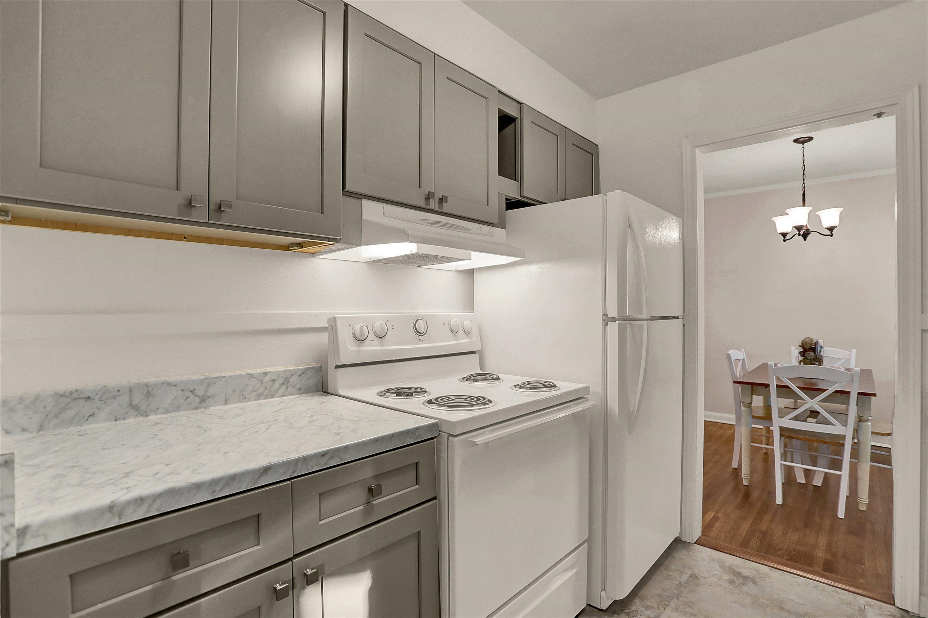 4607 Monaco Road Memphis, TN 38117 - Photo 10 of 25 a kitchen with stainless steel appliances granite countertop a refrigerator a stove and a sink with wooden floor
