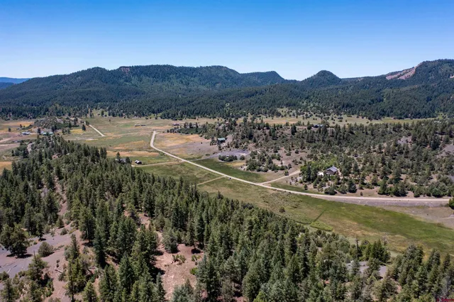 a view of a mountain with a mountain in the background