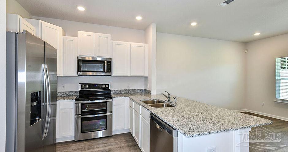 3 Egret Avenue, Unit PALM Santa Rosa Beach, FL 32459 - Photo 12 of 22 a kitchen with a sink stove and refrigerator