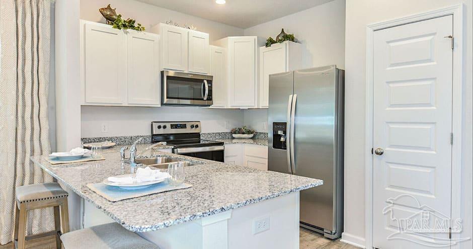 3 Egret Avenue, Unit PALM Santa Rosa Beach, FL 32459 - Photo 17 of 22 a kitchen with stainless steel appliances granite countertop a sink refrigerator and microwave