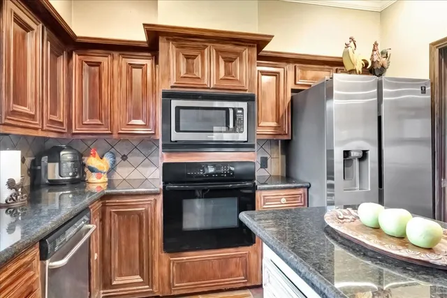 a kitchen with granite countertop a stove and cabinets