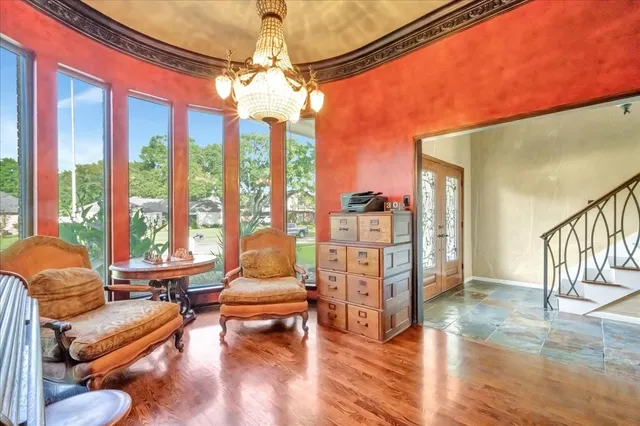 a living room with furniture and a chandelier