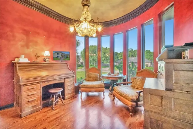 a living room with furniture a chandelier and a fireplace