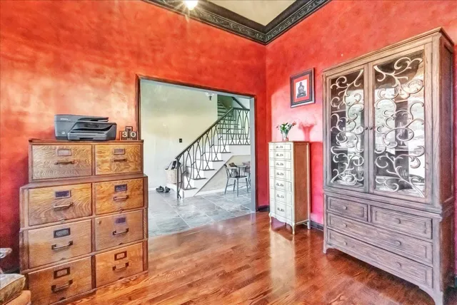 a view of an entryway with wooden floor and cabinet