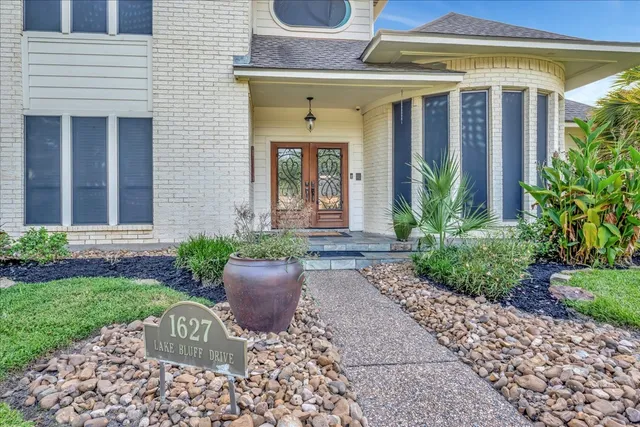 a front view of a house with garden