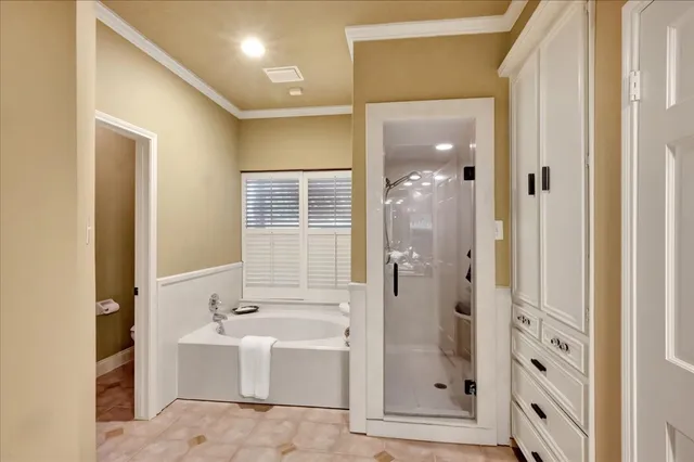 a bathroom with a tub shower and mirror