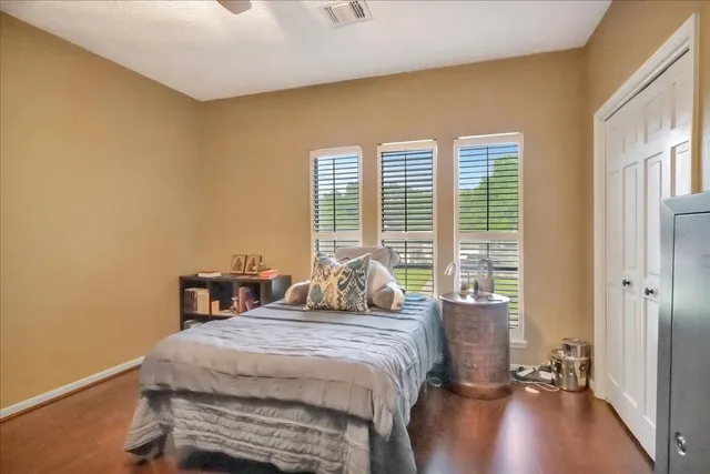 a bedroom with a bed and a large window