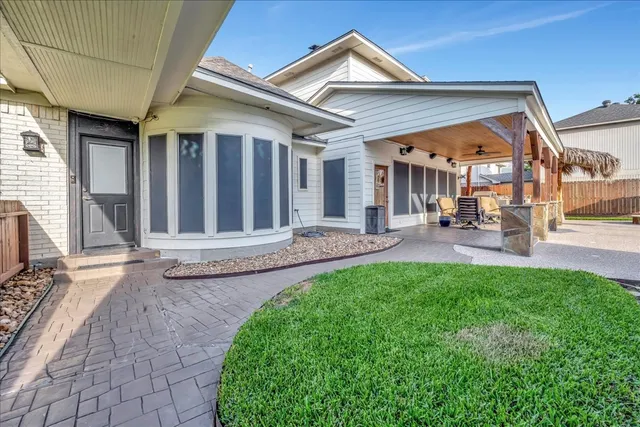 a view of a house with a yard and porch
