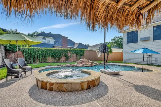 a view of a backyard with plants and a patio