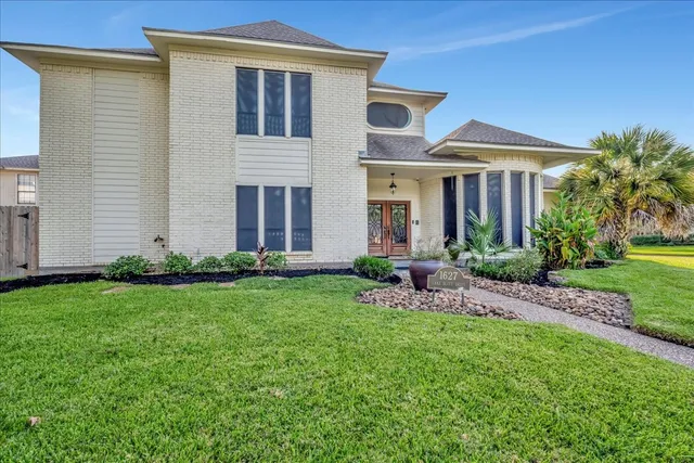 a front view of house with yard and green space