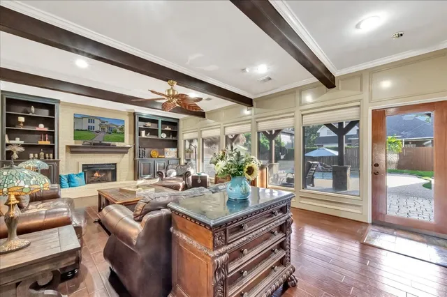 a living room with fireplace furniture and a large window