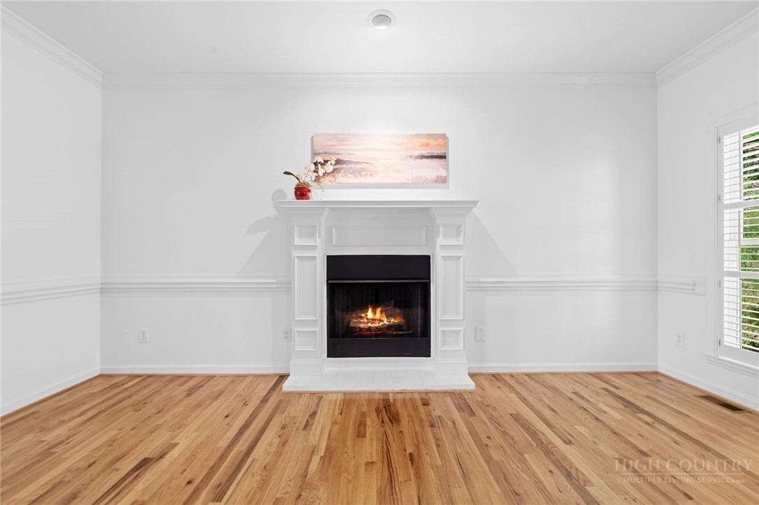 480 North Ridge Circle Boone, NC 28607 - Photo 5 of 50 a view of empty room with wooden floor and fireplace
