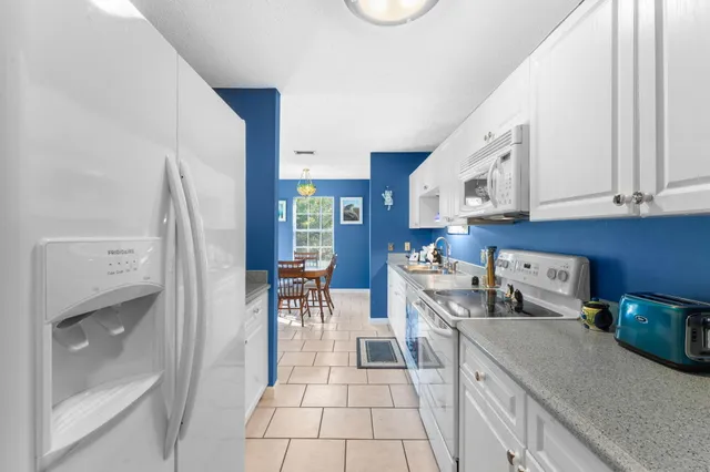 a kitchen with stainless steel appliances granite countertop a refrigerator and a stove