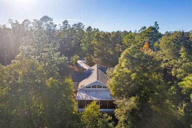 an aerial view of a house with a yard