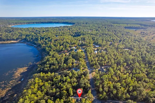 a view of a swimming pool with an outdoor seating and a yard