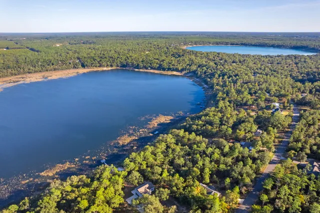 a view of a swimming pool with a lawn chairs under an umbrella