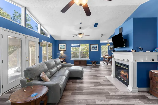 a living room with furniture a flat screen tv and a fireplace