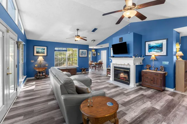 a living room with furniture a fireplace and a flat screen tv
