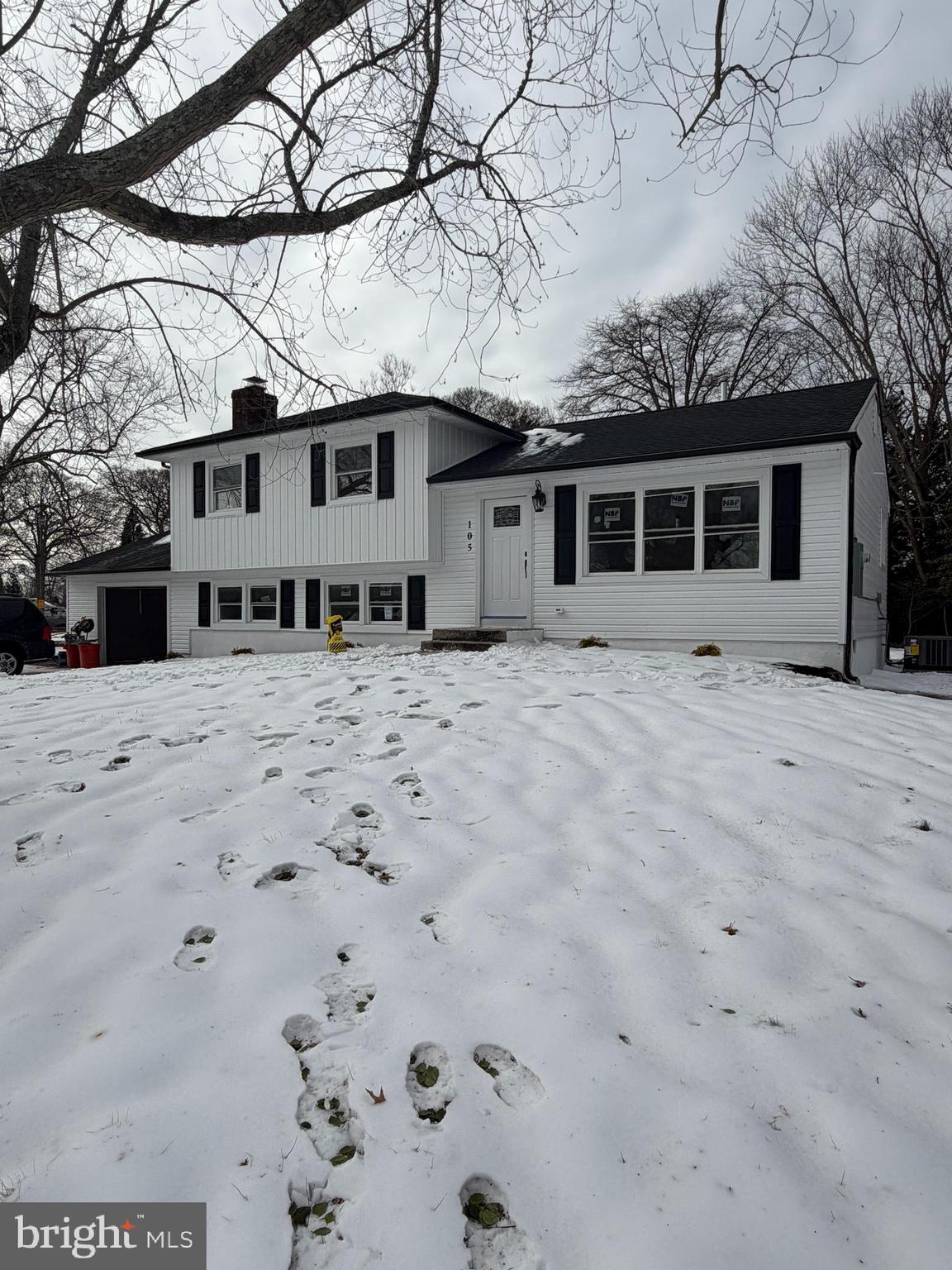 a front view of a house with yard covered in snow