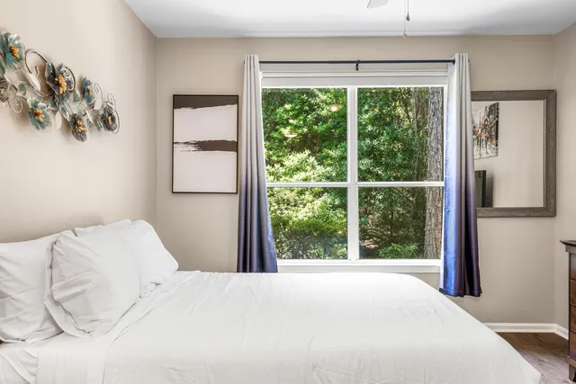 a bedroom with a large bed and a window