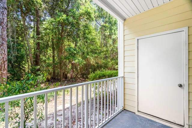 a view of a balcony with wooden floor