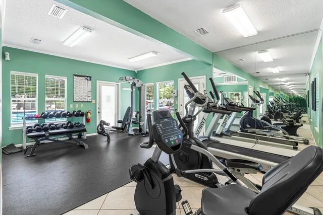 a gym room with lots of gym equipment