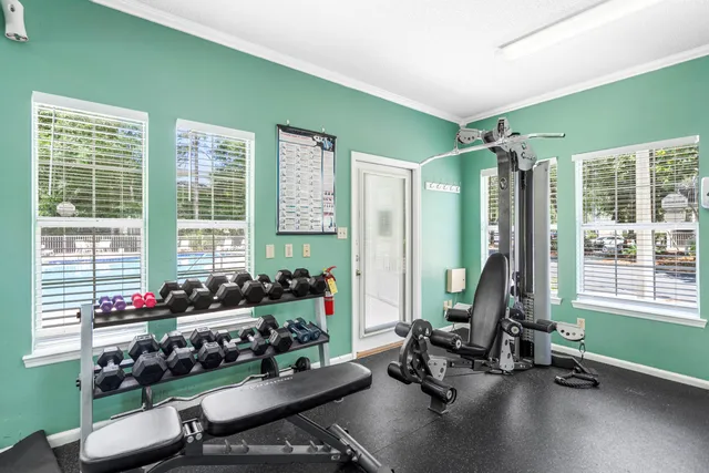 a room with gym equipment and floor to ceiling window