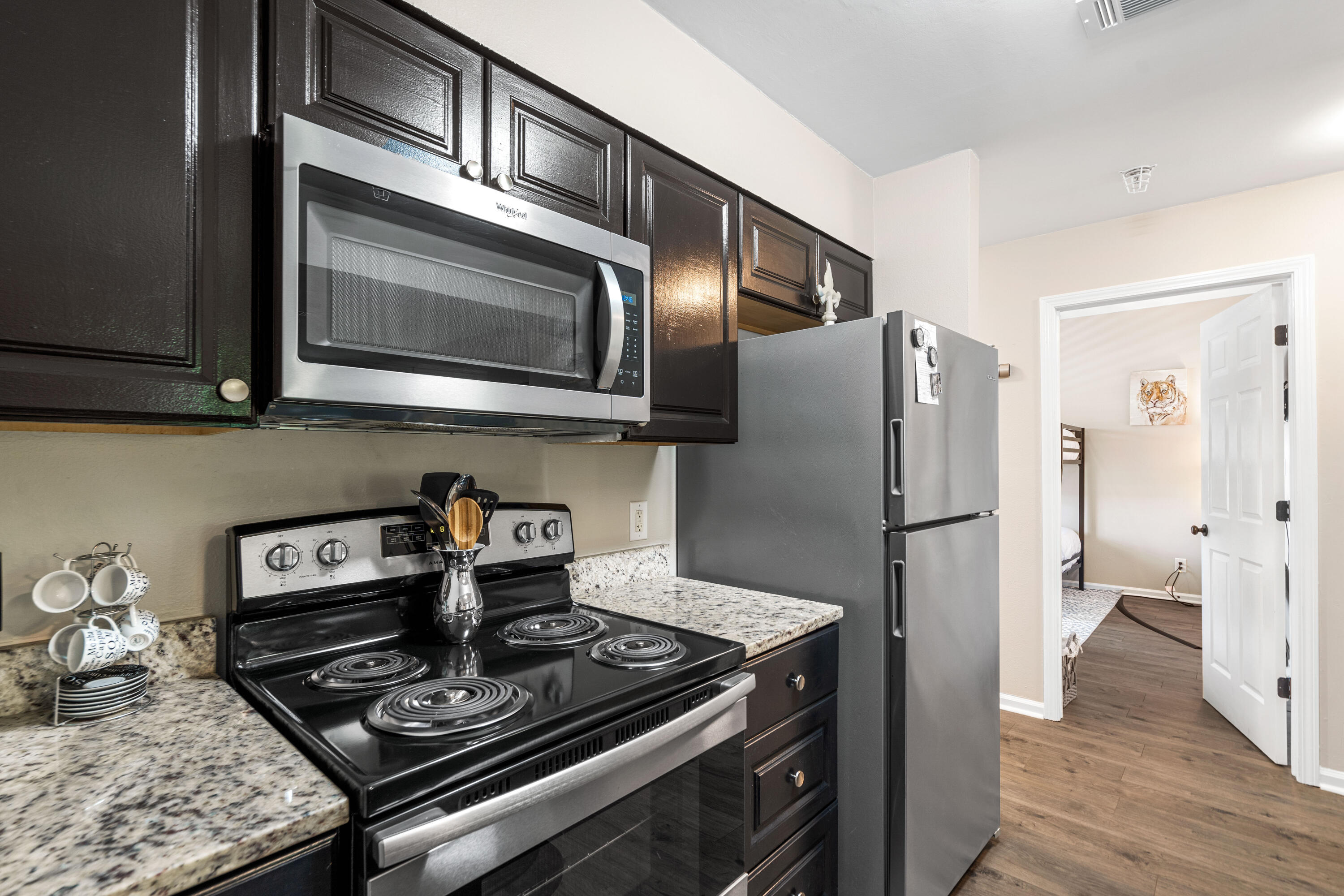 200 Sandestin Lane, Unit 1403 Miramar Beach, FL 32550 - Photo 4 of 37 a kitchen with stainless steel appliances granite countertop a stove and a refrigerator