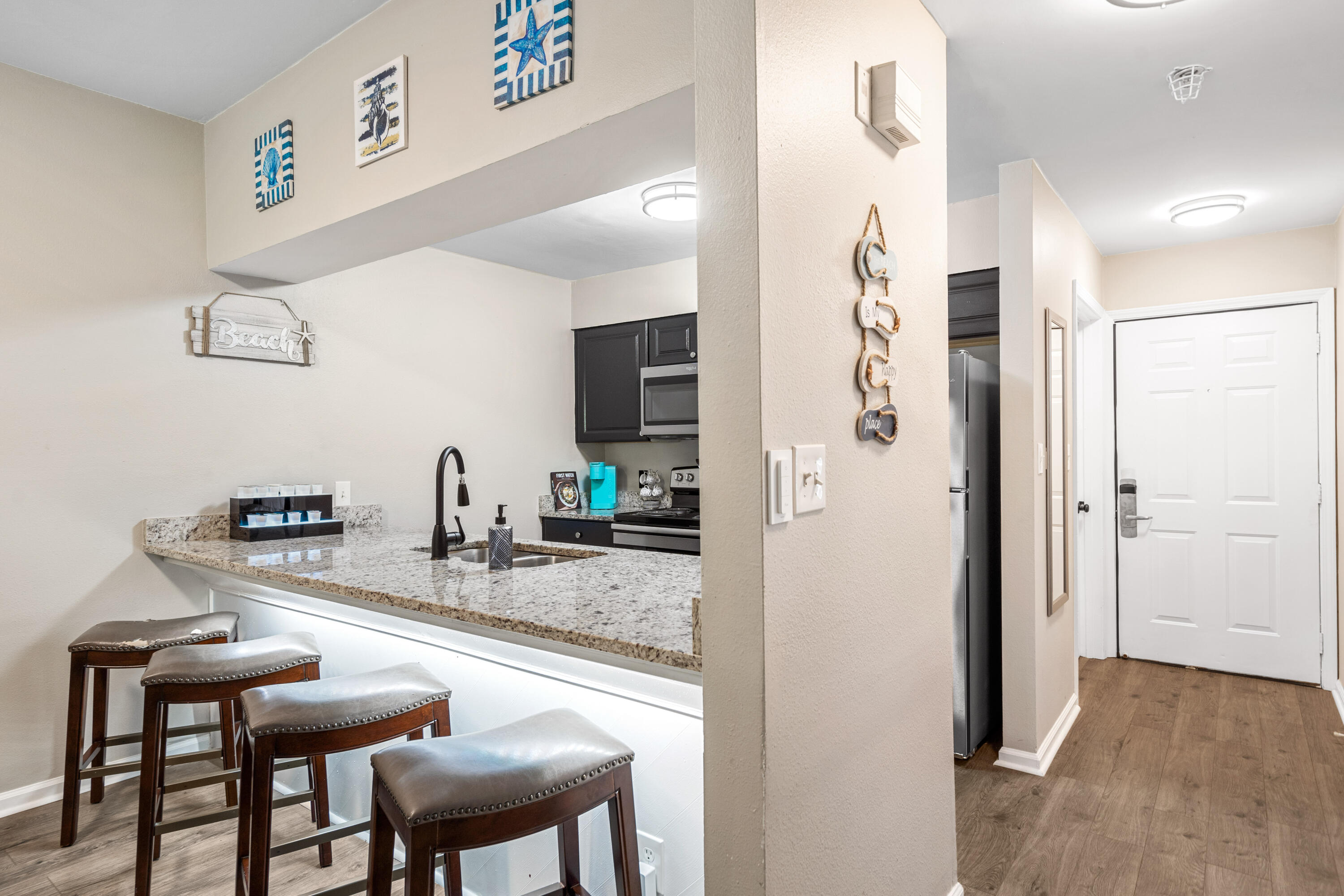 200 Sandestin Lane, Unit 1403 Miramar Beach, FL 32550 - Photo 5 of 37 a kitchen with stainless steel appliances granite countertop a refrigerator and a stove