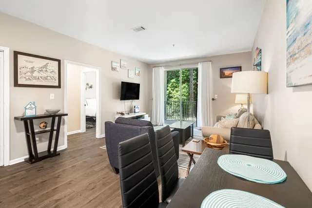 a living room with furniture fireplace and wooden floor