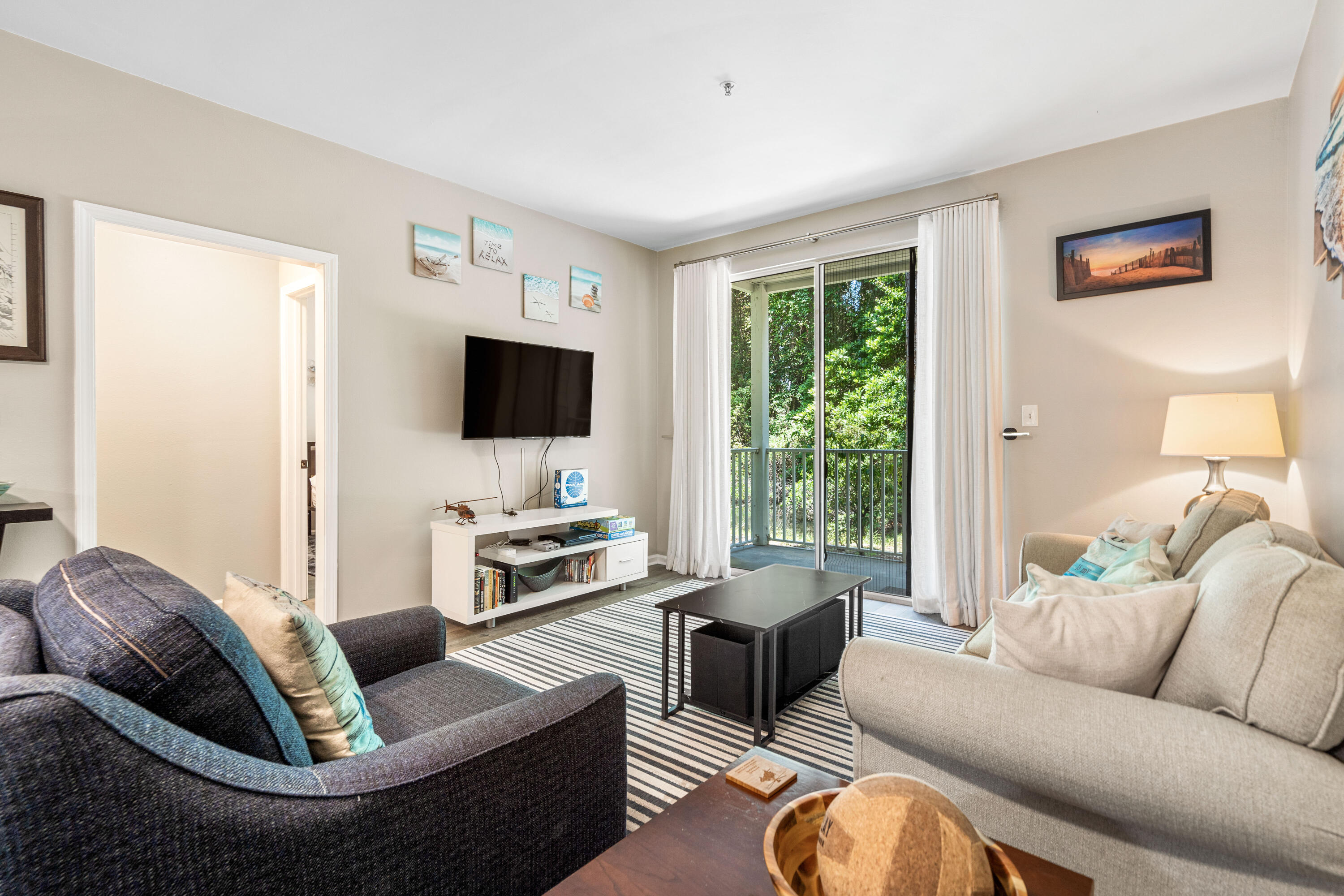 200 Sandestin Lane, Unit 1403 Miramar Beach, FL 32550 - Photo 8 of 37 a living room with furniture fireplace and a flat screen tv
