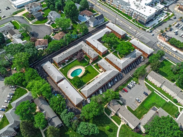 an aerial view of a house with a garden and swimming pool