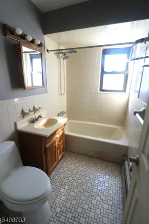 a bathroom with a sink a toilet and a bathtub